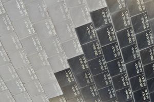 Close-up of the surface of the space shuttle, made up of individually labelled ceramic tiles. The photo is half grey tiles and half black tiles.