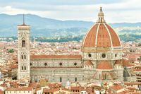 Cityscape of Florence's terracotta rooftops with the famous Cathedral in centre frame, dwarfing all of its neighbors.