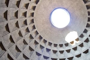 Lookup up at the sunlit opening in the Pantheon's ceiling. Relief work in the concrete circles this opening and casts shadows at different angles.