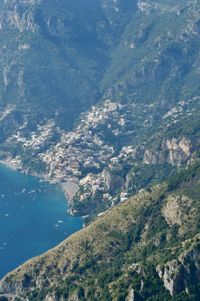 The view looking down over the coastal town of Positano. Most of the town's buildings are scattered across the steep cliff faces rising up from the ocean.