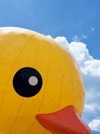 Looking up at an inflatable rubber duck several stories tall that's staring back with one cold, dead eye.